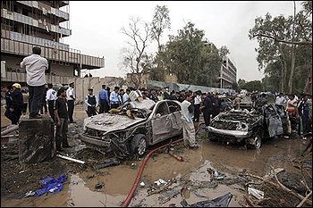 Iraqis gather at the site of a massive bomb attack in Baghdad, Iraq, Sunday, Oct. 25, 2009. Iraq police say that a pair of powerful explosions went off near the Ministry of Justice and the offices of a Kurdish political party during the morning rush hour as people headed to work. (AP Photo/Khalid Mohammed)